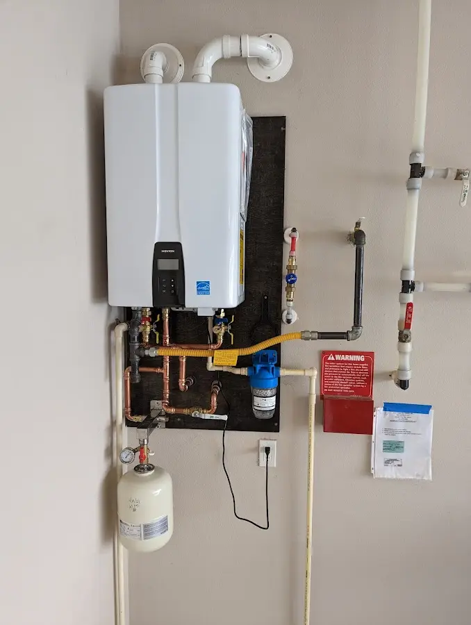 Professional plumber installing copper piping in a Georgetown home